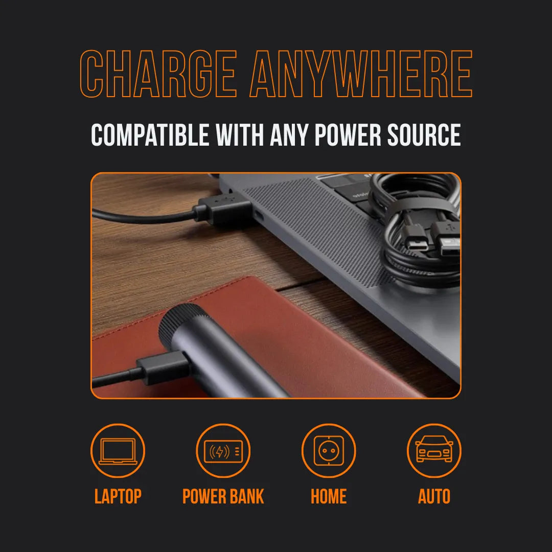 Portable device charging via laptop, cables and power options icons visible on wood desk